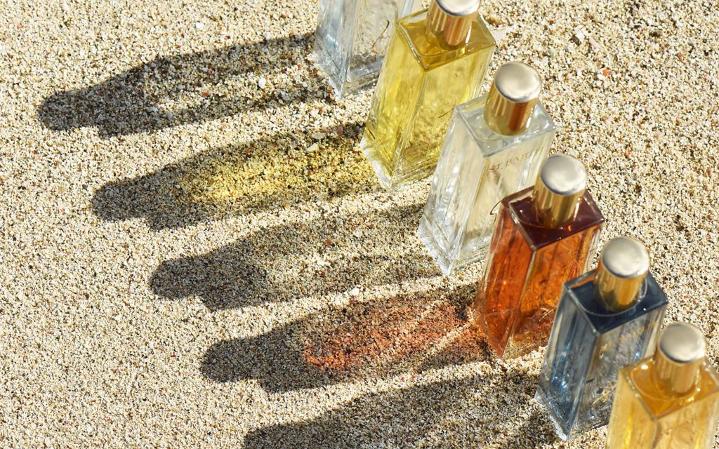 Beauty shot of Ligne St. Barth fragrances on sand