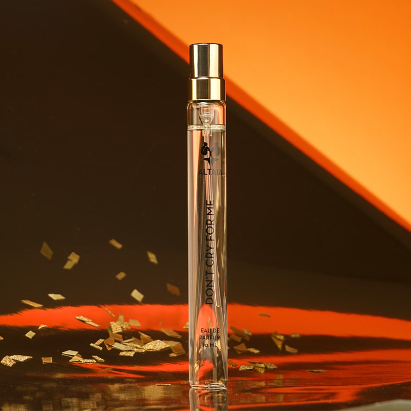 ALTAIA Don't Cry For Me Eau de Parfum Travel Spray  with gold sprinkles and orange and brown background.
