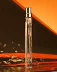 ALTAIA Don't Cry For Me Eau de Parfum Travel Spray with gold sprinkles and orange and brown background.