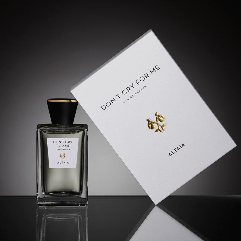 Beauty shot of ALTAIA Don&#39;t Cry For Me Eau de Parfum 100 ml and box with a black background