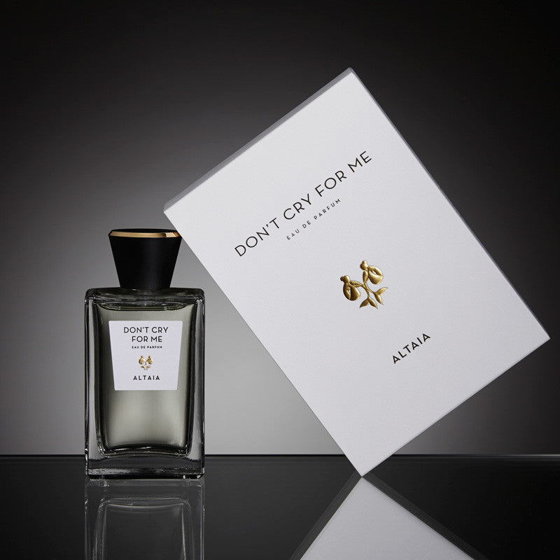 Beauty shot of ALTAIA Don't Cry For Me Eau de Parfum 100 ml and box with a black background