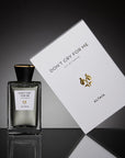 Beauty shot of ALTAIA Don't Cry For Me Eau de Parfum 100 ml and box with a black background