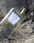 Beauty shot of ALTAIA Don't Cry For Me Eau de Parfum with cap off and wood in the background