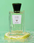 Beauty shot of ALTAIA Yu Son Eau de Parfum sitting on a slice of lemon and water in the background