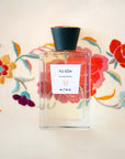 Beauty shot of ALTAIA Yu Son Eau de Parfum with embroidered flowers in the background