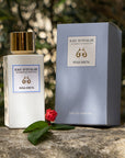 Lifestyle shot of Eau d'Italie Rosa Greta Eau de Parfum Spray bottle (100 ml) and box with a single pink rose bud in the foreground