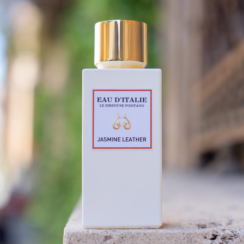 Lifestyle shot of Eau d'Italie Jasmine Leather Eau de Parfum Spray (100 ml) on stone ledge