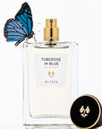 Beauty shot of ALTAIA Tuberose in Blue Eau de Parfum - 100 ml with cap off and blue butterfly on bottle