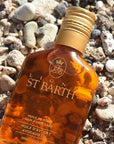 Ligne St. Barth Avocado Oil (6.8 oz) top view on top of rocky beach