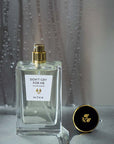 Beauty shot of ALTAIA Don't Cry For Me Eau de Parfum with cap off and water dripping down in the background