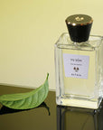 Beauty shot of ALTAIA Yu Son Eau de Parfum with single green leaf in the background