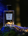 Beauty shot of ALTAIA Tuberose in Blue Eau de Parfum with purple powder in the background