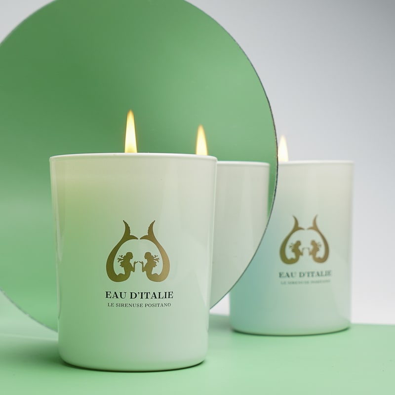 Eau d&#39;Italie Scented Candle (190 g) shown burning with circle mirror in the background