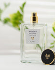 Lifestyle shot of ALTAIA Wonder of You Eau de Parfum (100 ml) with top of bottle off and posed facing front