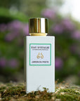 Lifestyle shot of Eau d'Italie Jardin du Poete Eau de Parfum Spray (100 ml) with purple flowers in the background