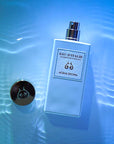 Lifestyle shot top view of Eau d'Italie Acqua Decima Eau de Parfum Spray (100 ml) in water with blue background