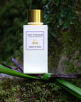 Lifestyle shot of Morn to Dusk Eau de Parfum Spray (100 ml) with vanilla pod wrapped with leaves in the foreground