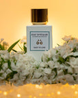 Lifestyle shot of Eau d'Italie Easy to Love Eau de Parfum Spray (100 ml) with white flowers in the background and foreground