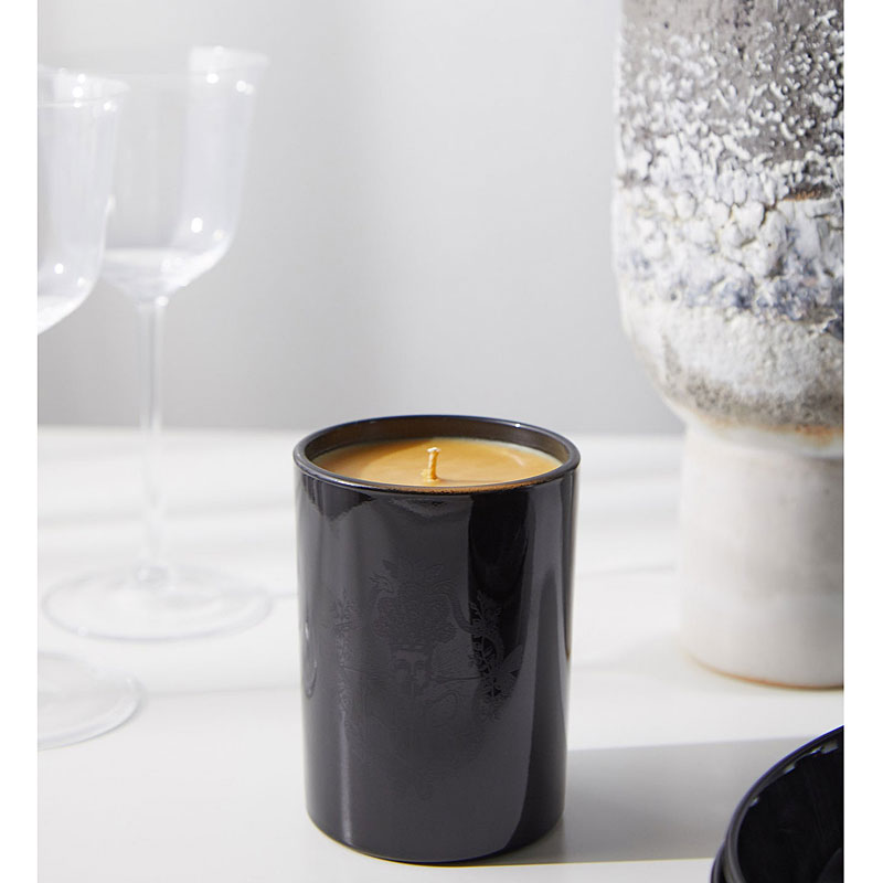 Harris Reed Palo Santo Epilogue Candle - lifestyle shot with wine glasses (not included)
