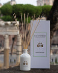 Lifestyle shot of Eau d’Italie Signature Scent Diffuser (240 ml) with box and ruins in the background