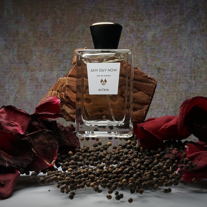 ALTAIA Any Day Now Eau de Parfum - Product shown in front of bark , dried rose petals on each side