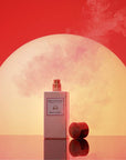 Eau d'Italie Mystic Sunset Eau de Parfum Spray showing with lid off in front of a sunset