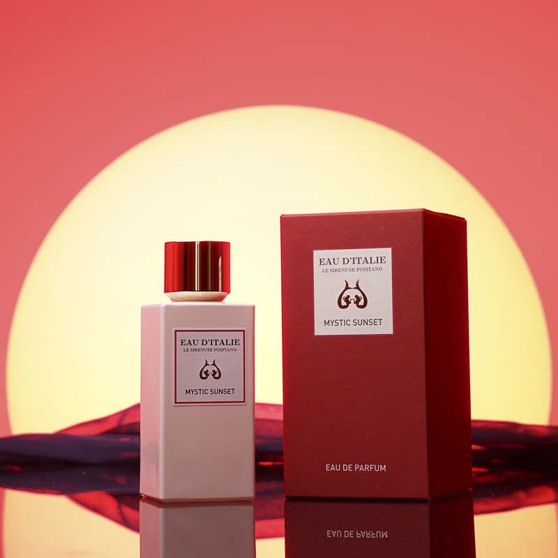 Eau d'Italie Mystic Sunset Eau de Parfum Spray showing sitting next to packaging in front of a sunset