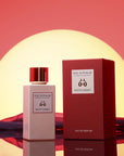 Eau d'Italie Mystic Sunset Eau de Parfum Spray showing sitting next to packaging in front of a sunset