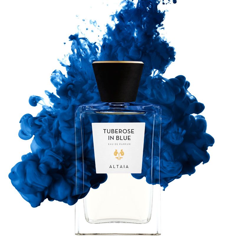 Beauty shot of ALTAIA Tuberose in Blue Eau de Parfum - 100 ml with blue liquid in the background 